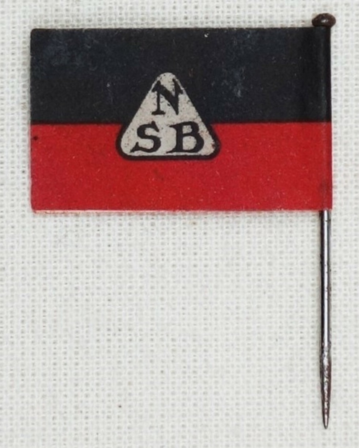 Lapel pin of the National Socialist Movement in the Netherlands. The colours red and black stood for their Blood and Soil ('Bloed en Bodem') theories.