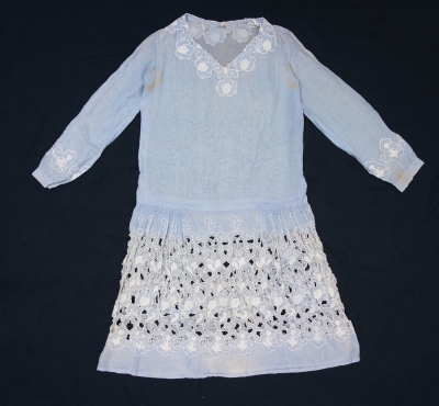 Dress made of a powder blue cotton material and decorated with cutwork and abstract organic shapes, all in white.  The Netherlands, 1920s.