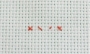 Piece of Aida material with a simple cross stitch indicated in red.  