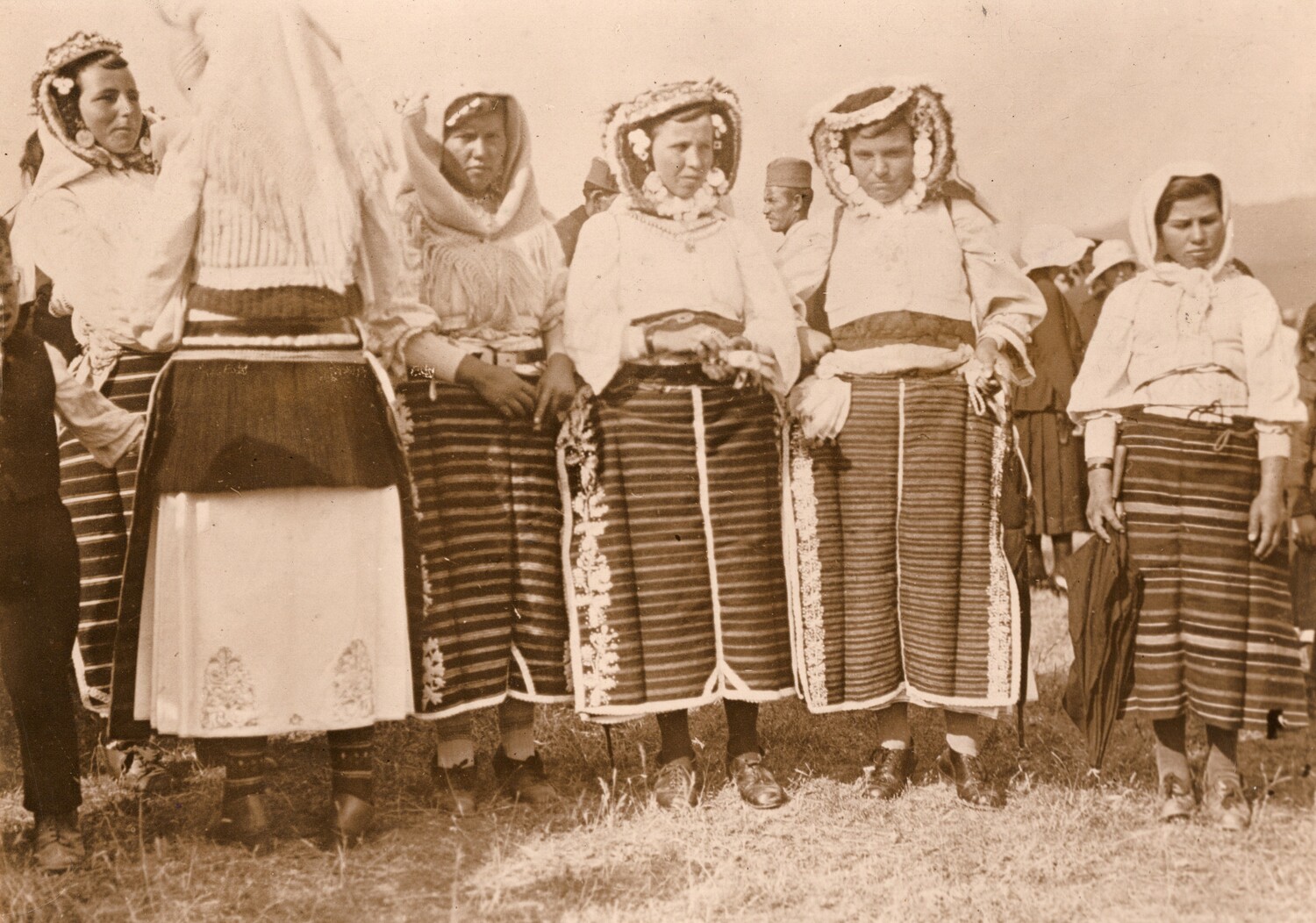 Fig. 11. A mid-twentieth century postcard from southern Serbia , with a group of six women wearing regional dress including woven aprons (TRC 2017.2269).
