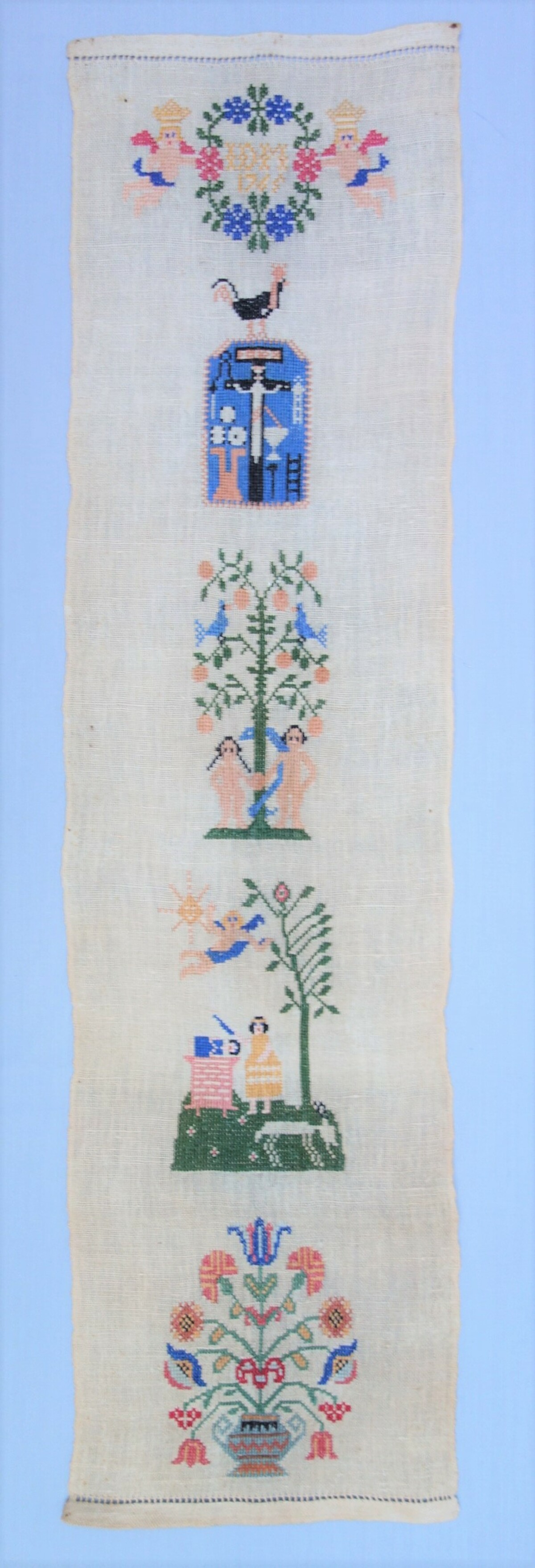 Band sampler in pristine condition, likely based on a 1942 sampler book (including the pattern on top with the date of 1765) (TRC 2019.2921).