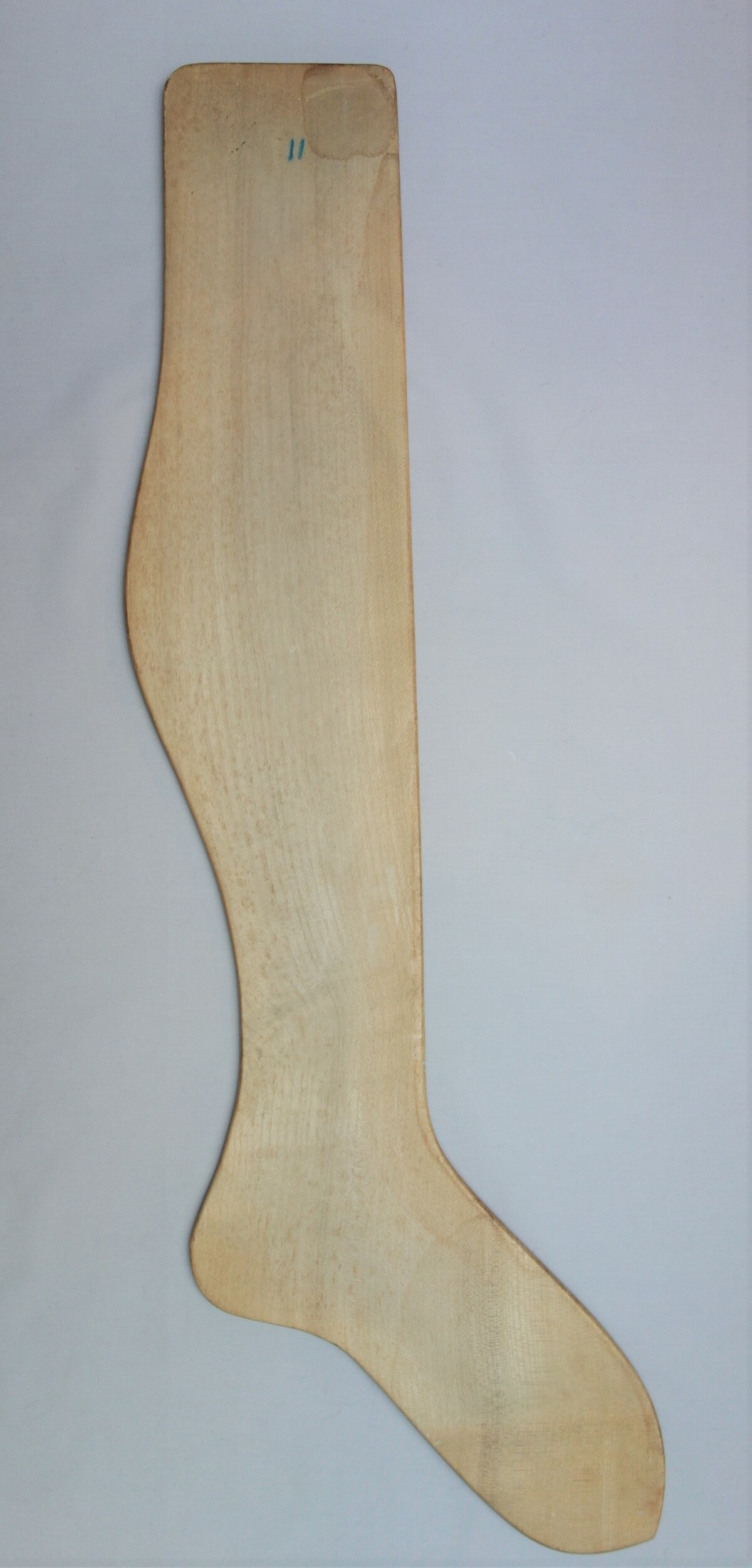 A wooden stocking form (TRC 2020.0140).