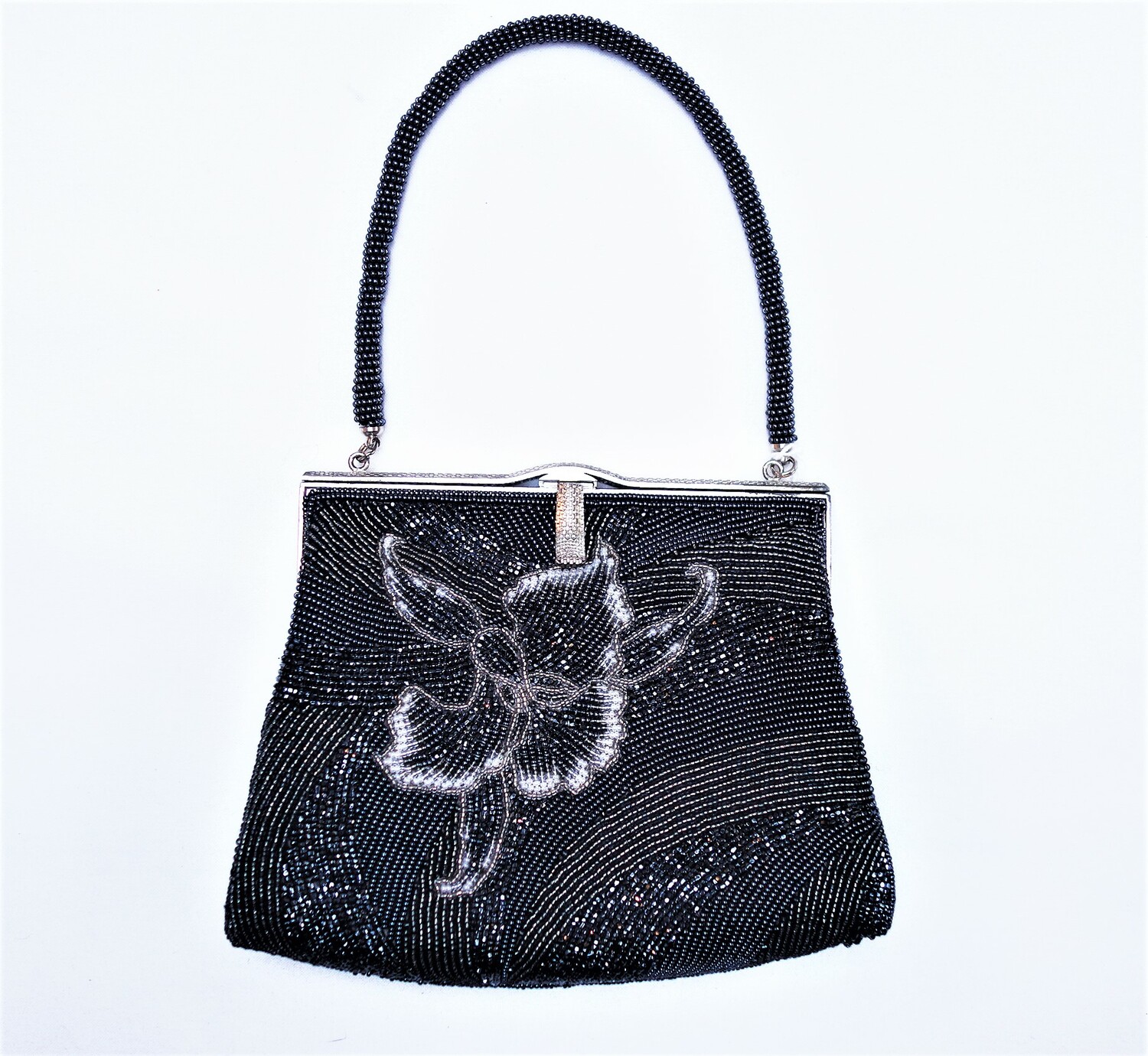 A beaded bag with a design of stylised flowers in black beads, Japan, 1960s-1970s (TRC 2021.0634).