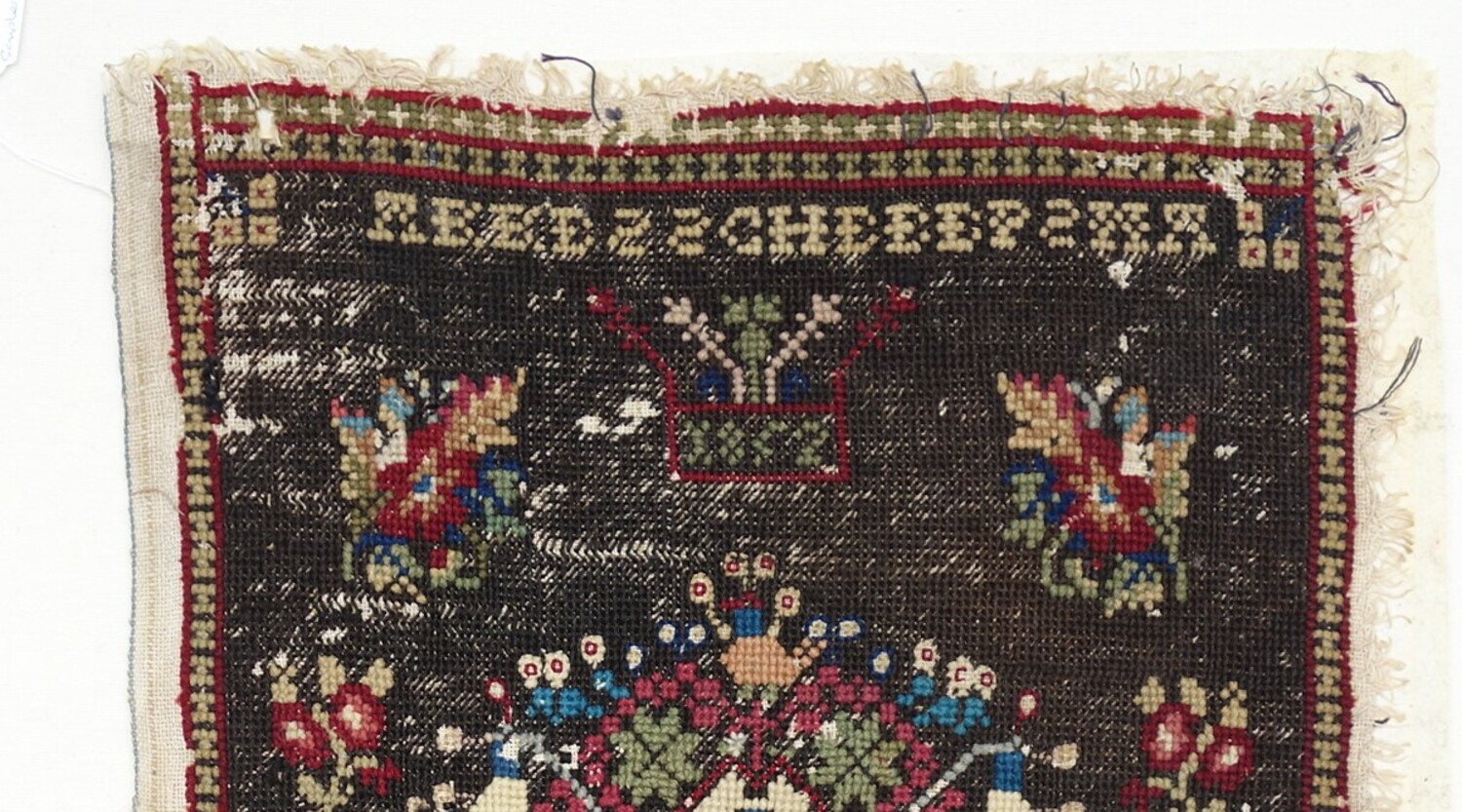 Detail of sampler made by Akke Scheepsma aged 12 or 13 in 1852, in Schettens, Friesland (TRC 2021.1805).