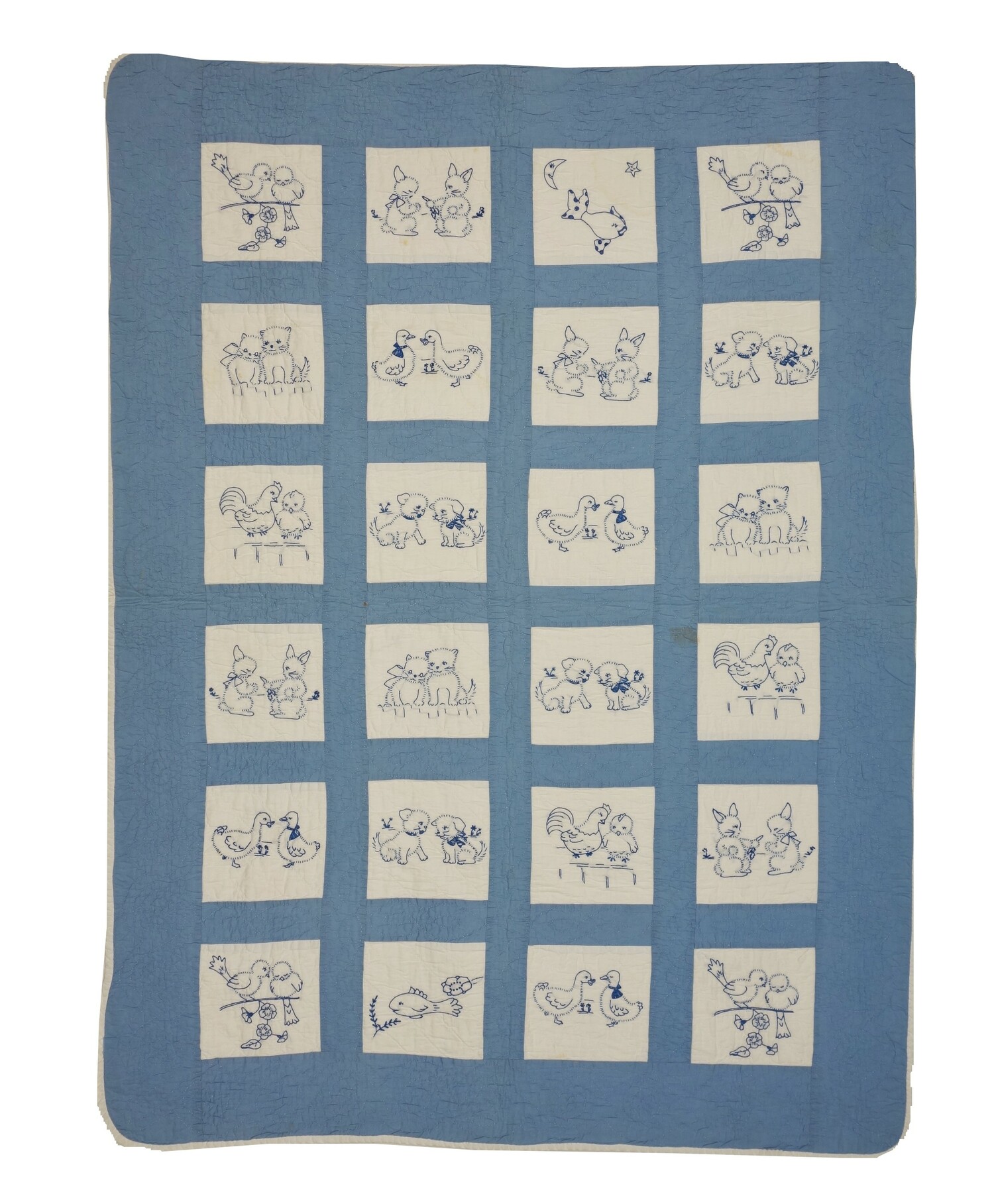 A child’s quilt embroidered with baby animals including rabbits, chickens, kittens and puppies from about the 1930’s (TRC 2022.1147).