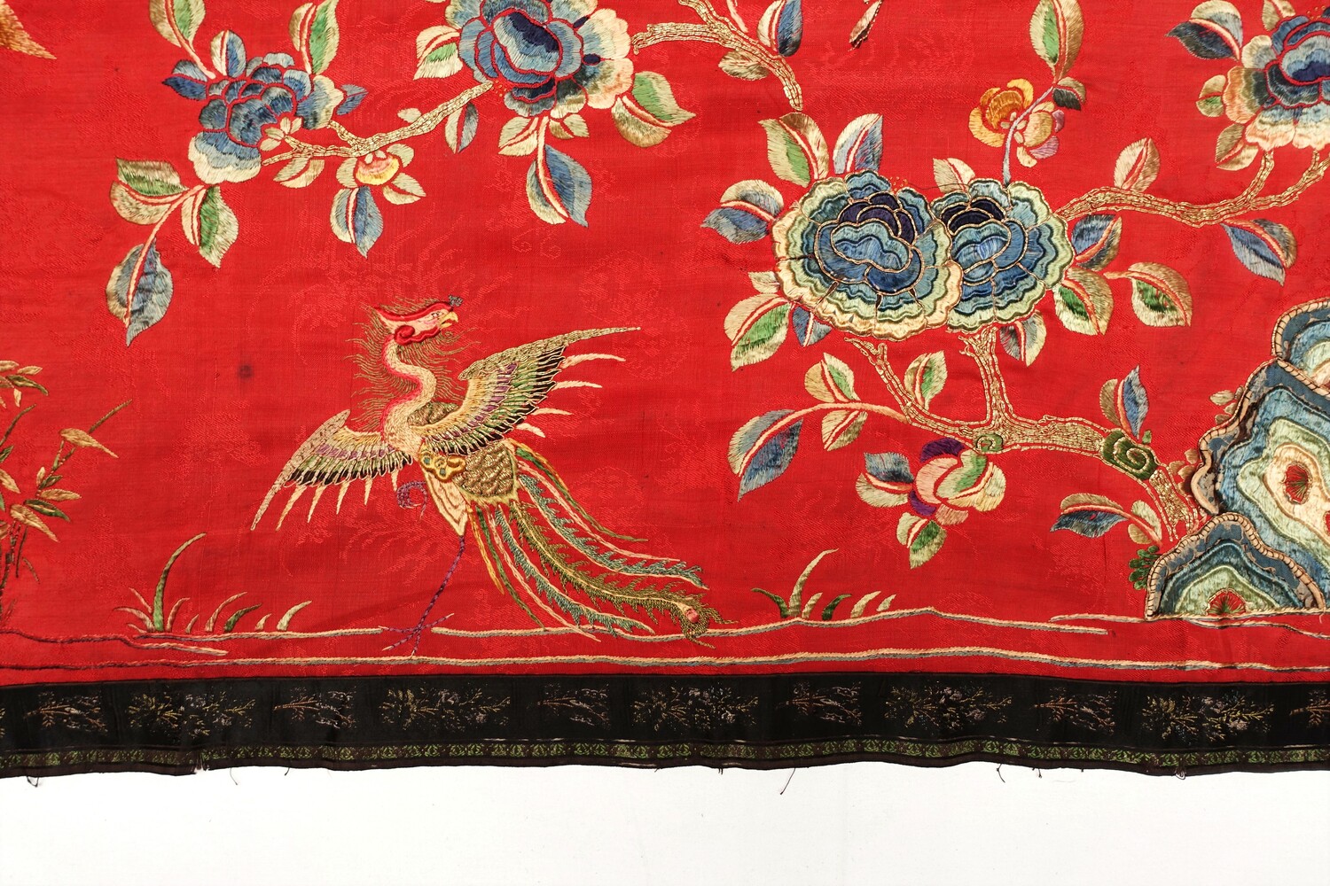 Fig. 10. Detail of a cloth with an embroidered pattern of stylised floral motifs and birds (including phoenixes) worked in various colours. China, early 20th century (TRC 2022.2694).