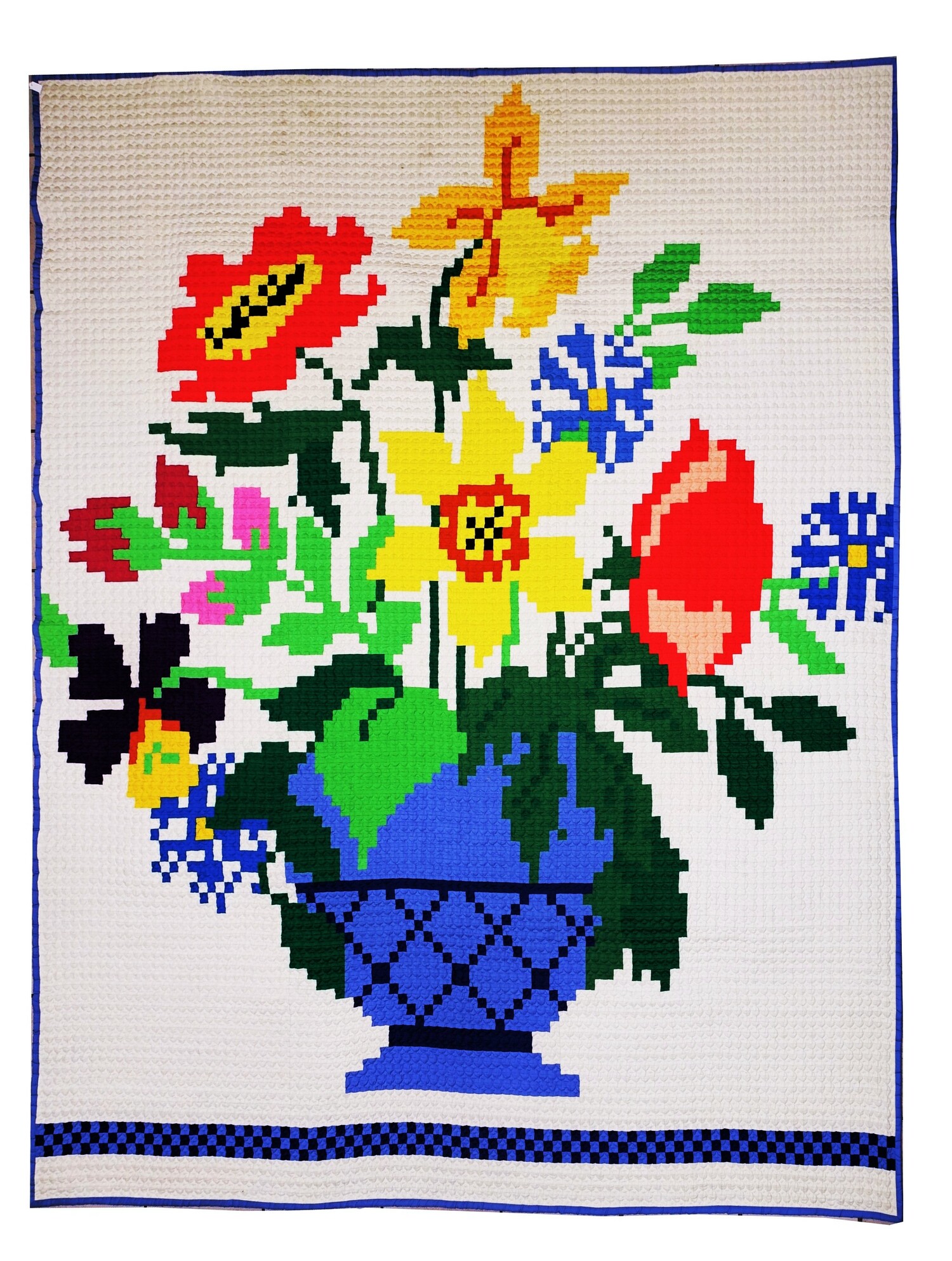 A quilt based on a cross stitch design made by Roberta Cook in 1985, using 10,058 one-inch squares, which she named ‘Basket Case’ (TRC 2022.2745).