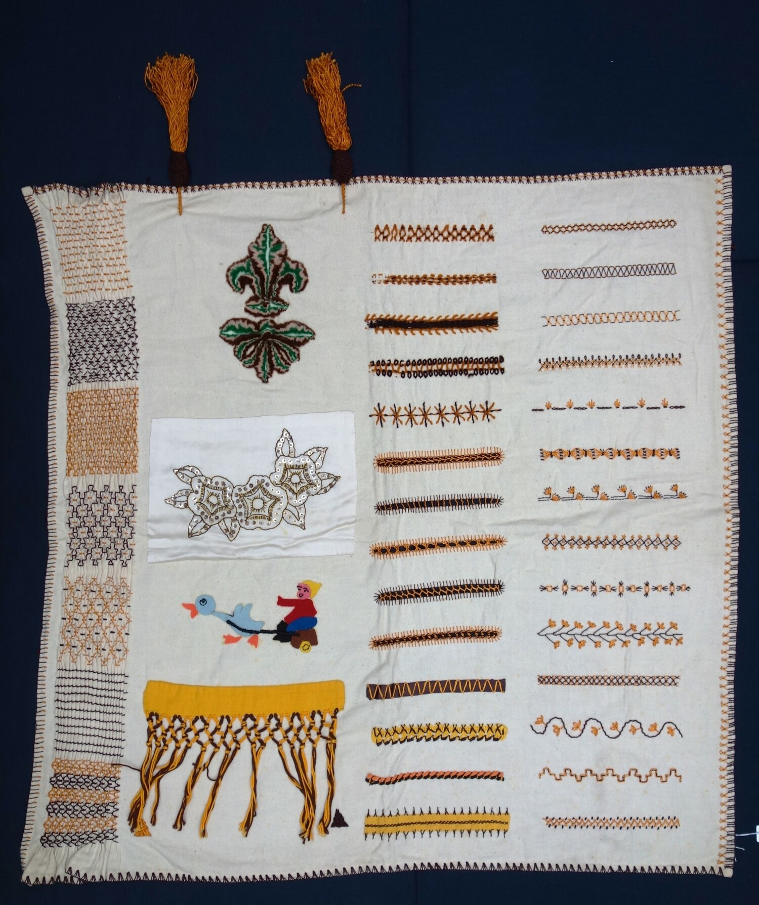 Large sampler with a variety of stitches and techniques including embroidery, smocking, pile work, fringing, etc. The Netherlands, 20th century (TRC 2024.0198).