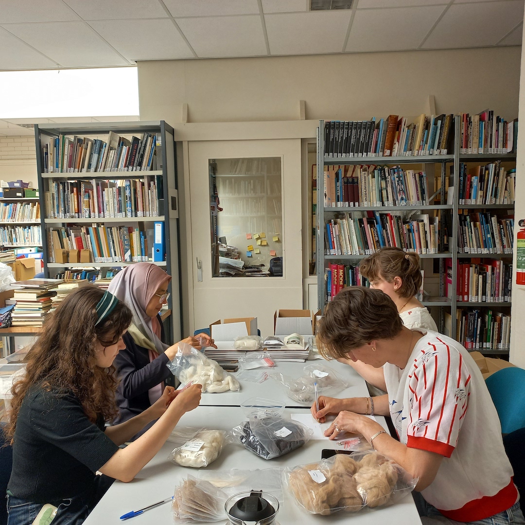 Students at the TRC sorting and studying fibres for the sample collection. Photograph by author.