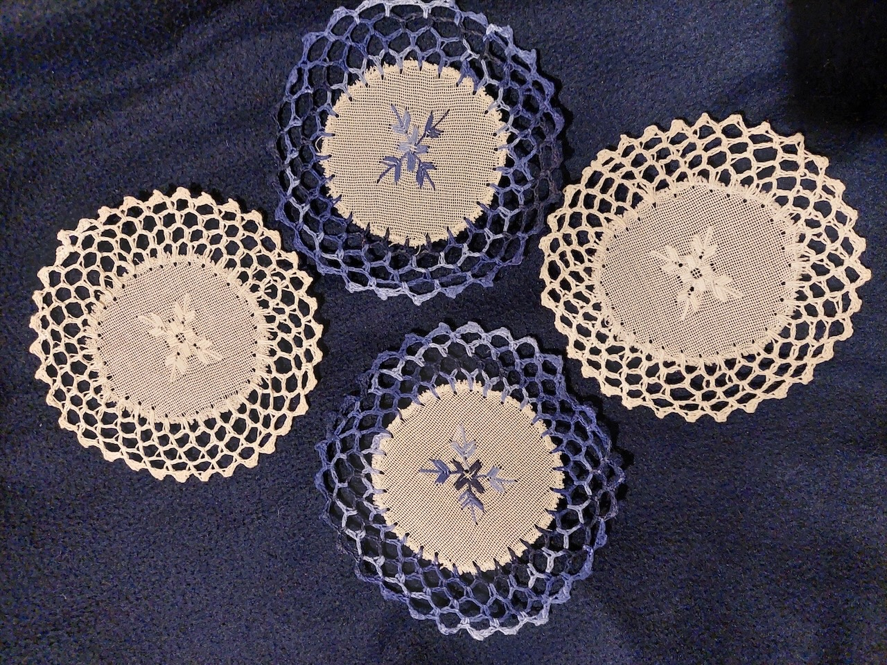 Four blue and white nanduti lace coasters, cotton, 2025, Paraguay (TRC 2026.0647a-d).