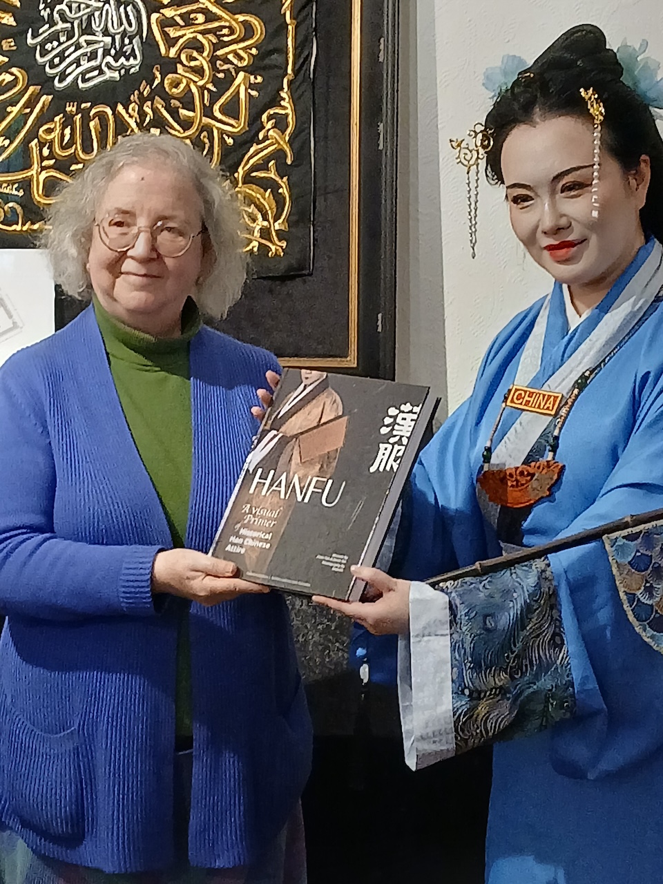 Danni Wang presents a copy of the Hanfu book to Gillian Vogelsang.
