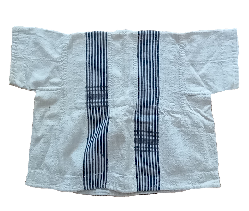 Fig. 4. Child's cotton tunic made up of numerous narrow strips of hand woven cloth. Late 20th century, Sahel, Africa. TRC 2026.0335.