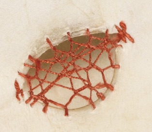 A small parchment hole filled with Cretan stitch in a ‘lacy’ manner (Engelberg, Stiftsbibliothek / Cod. 16 – Augustinus, Sermones ad populum diversi / f. 108r).