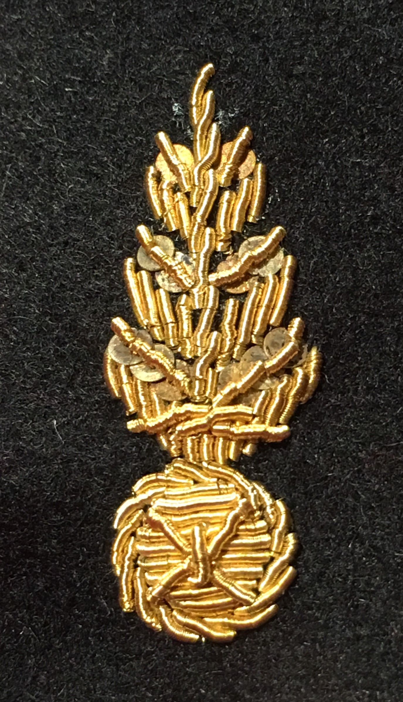 Pinecone (fragmentation) grenade motif, worked in gold thread, from the Maison des Grenadières, Cervières, France.