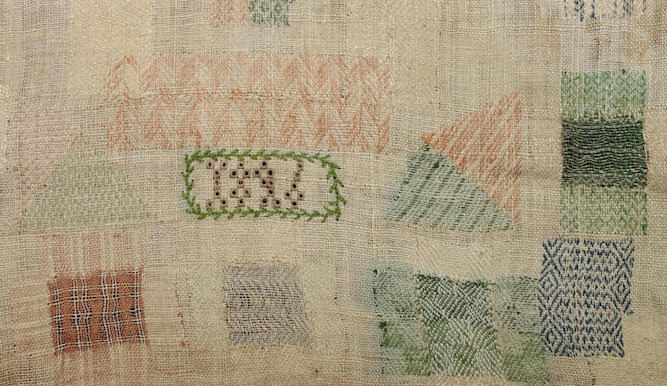 Detail of darning sampler TRC 2024.2672, with the date of 1826 in the centre.