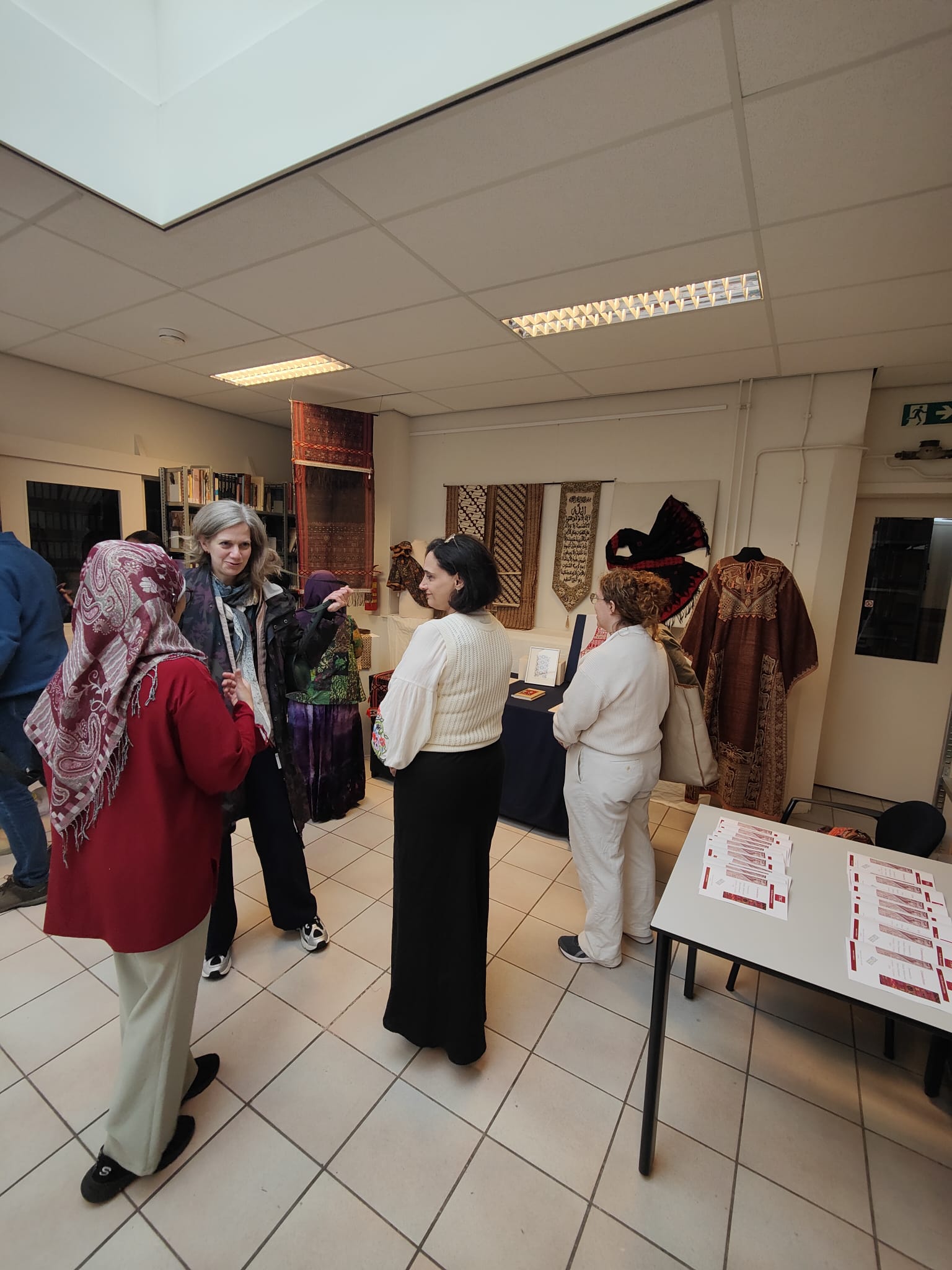 Standing and talking during the opening of the mini exhibition.