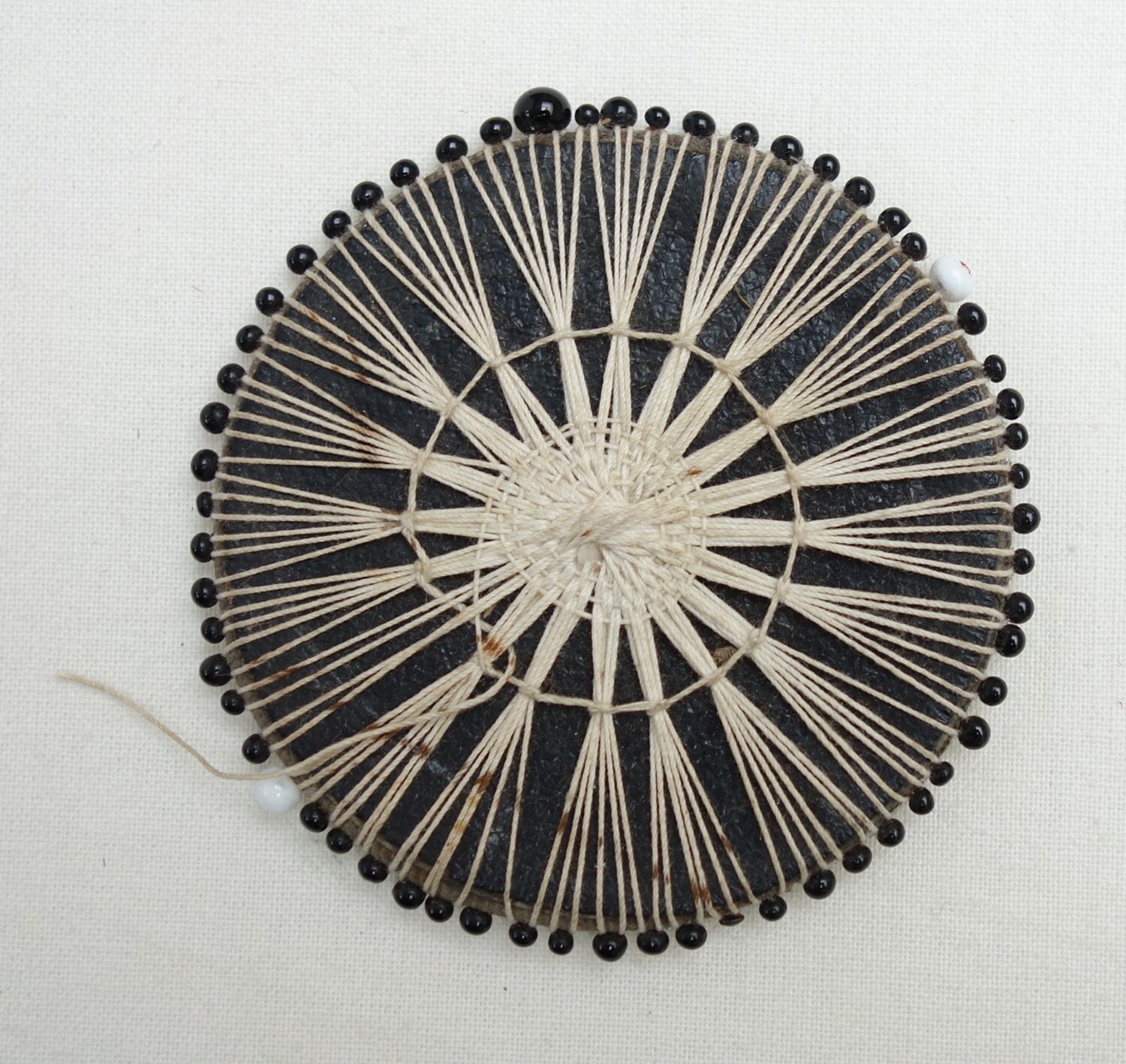 A 'Vicars' Lace Tablet', with pins around the outer  edges, UK, late 19th century (TRC 2015.0632).