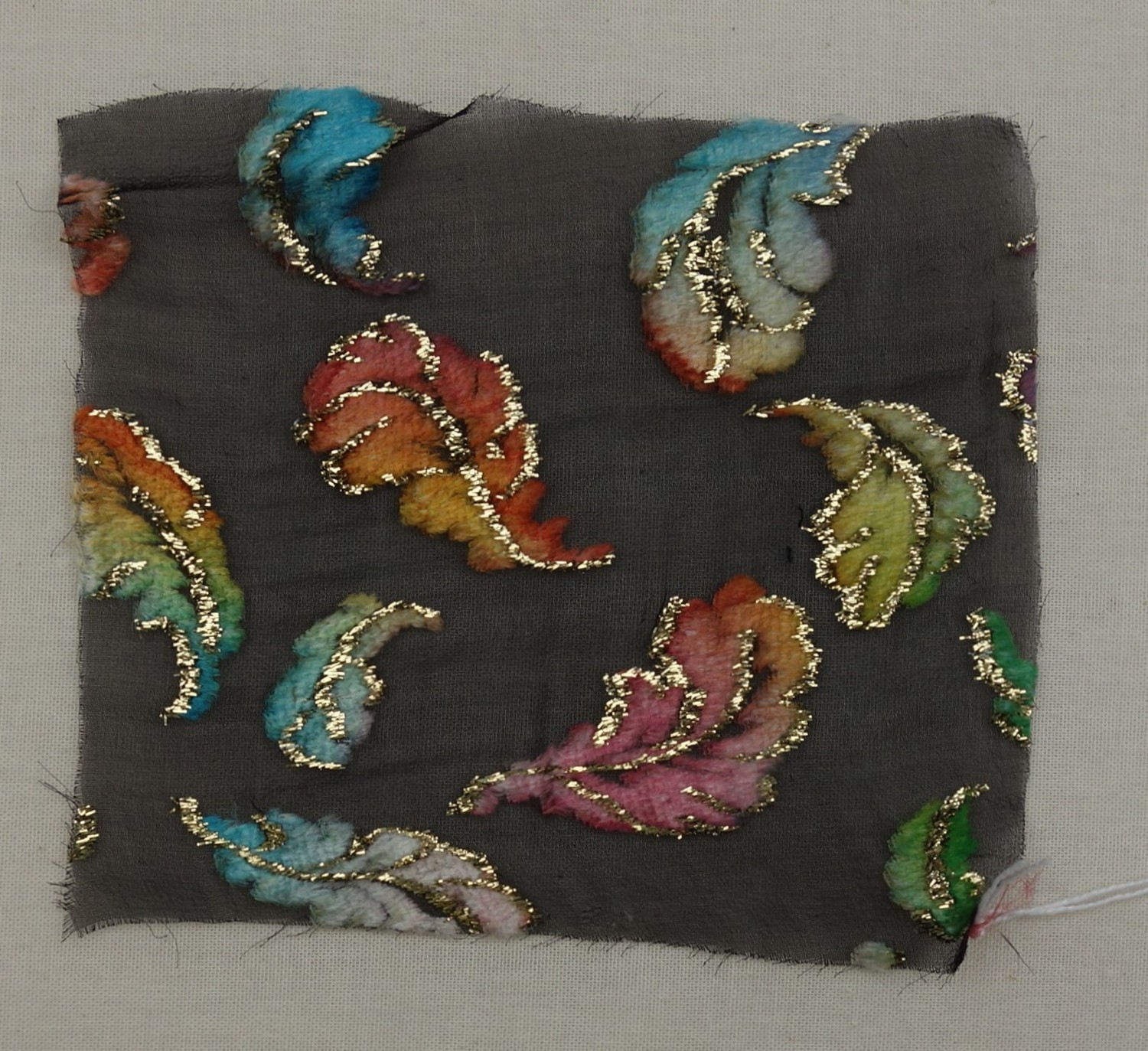 Sample of devoré velvet with a design of feathers outlined with metal thread. Late-20th century (TRC 2017.0551).