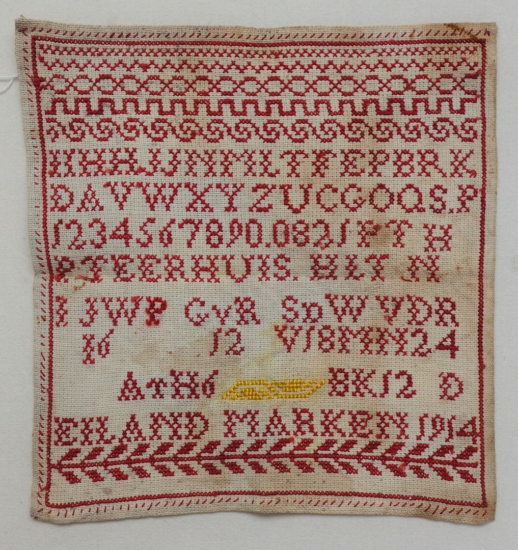 School sampler with rows of simple designs, letters, numbers and various initials. It includes the text: "EILAND MARKEN 1914" (TRC 2018.2382).