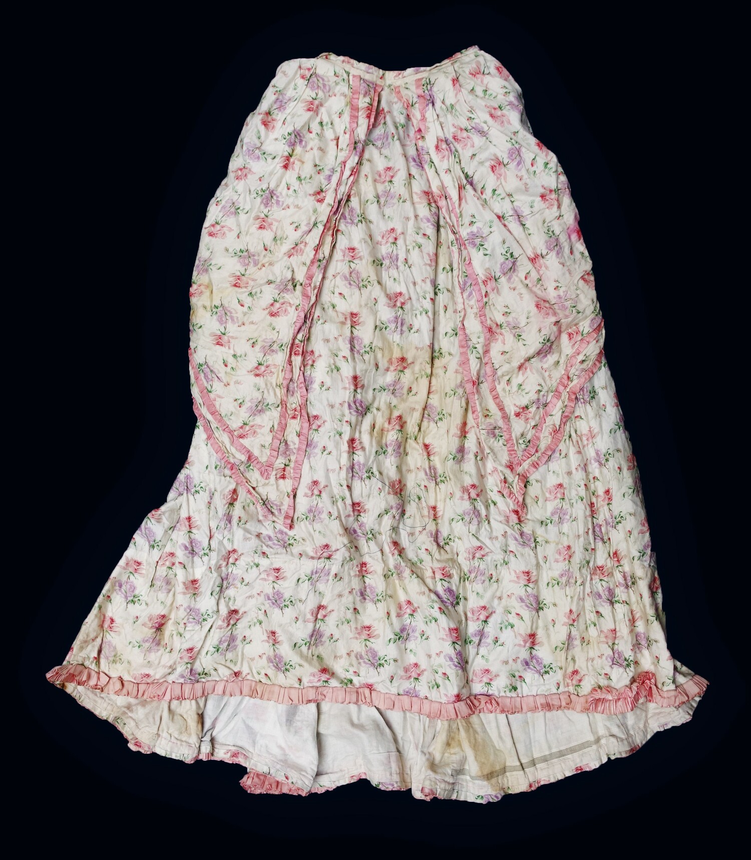 Full length bustled, cotton and silk skirt in white with printed pink and purple floral motifs (TRC 2022.2726a). The inside pocket contained the embroidered handkerchief TRC 2022.2726b. 19th century, Europe.