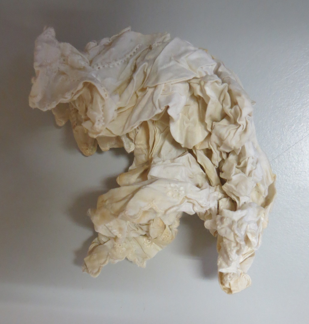 Crumpled embroidered handkerchief (TRC 2022.2726b), found inside a pocket of 19th century skirt TRC 2022.2726a.