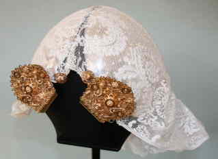 Lace cap with golden jewellery over a silver casque. Northeast Netherlands. TRC collection.